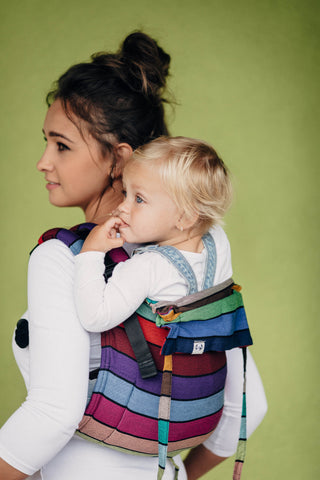 Child being carrier in Lenny Lamb brand baby carrier onbuhimo in print Carousel of Colors