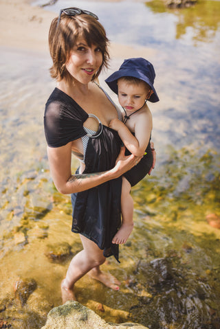model wears child in black mesh water ring sling