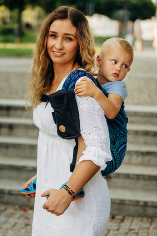 Portable baby carrier pocket for carrier strap
