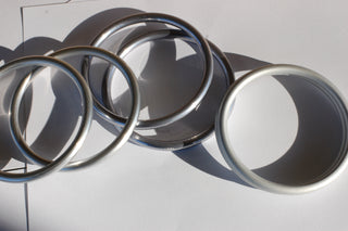 medium hand-buffed silver sling rings (left), medium hand-buffed Slate sling rings (middle), medium silver sling ring (right)