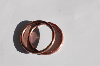 small hand-buffed rose gold sling rings
