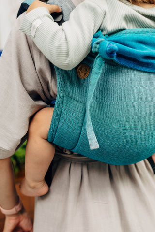 Child being carried in LennyLamb brand onbuhimo waist-less baby carrier in design Airglow, available at Mama & Roo's