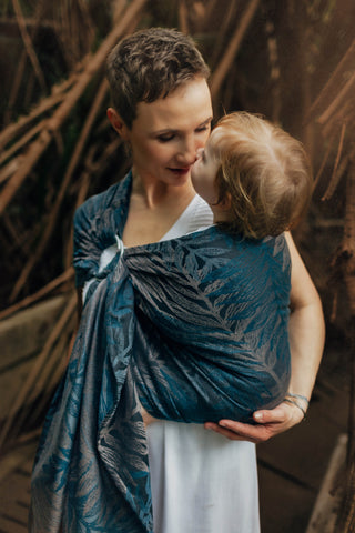Womnan holding child in ring sling. Rainforest - Nocturnal design
