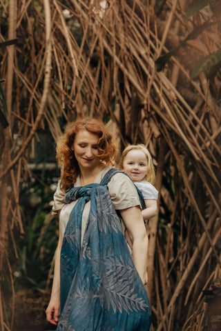 Woman holding child in long woven wrap in the Rainforest - Nocturnal design