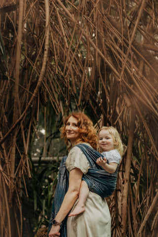 Woman holding child in long woven wrap in the Rainforest - Nocturnal design