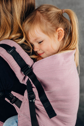 Preschool carrier in Little herringbone - Ombre Pink. Close up of toddler in a back carry position. 