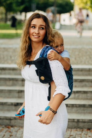 Portable baby carrier pocket for carrier strap