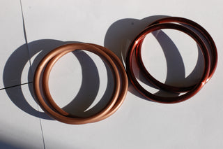 Medium Bronze ring slings (left) next to medium hand-buffed Brown ring slings (right)