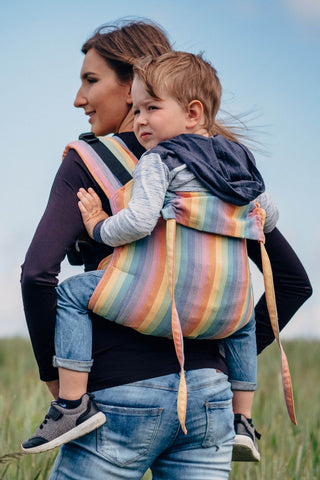 Lenny Lamb brand buckle onbuhimo baby carrier in print Luna in a spring field. Back view at an angle