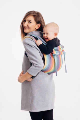 Lenny Lamb brand buckle onbuhimo baby carrier in print Luna. Model is wearing winter dress. White background. Smiling