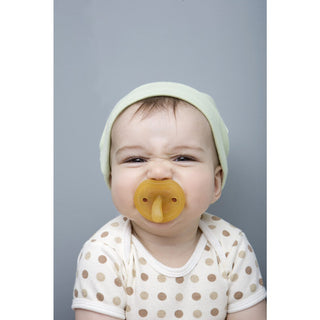 Baby using Natursutten rubber Butterfly pacifier. Made in Italy.